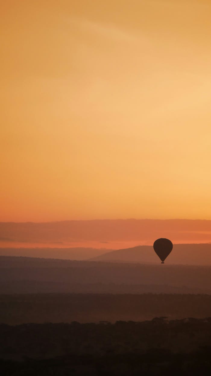 featured-portfolio-02 Captivating view of a hot air balloon silhouetted against a stunning African sunset.