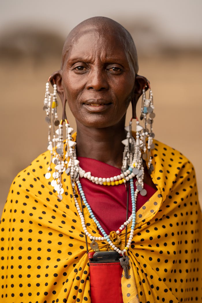 Maasai woman adorned in traditional attire and jewelry in Tanzania.